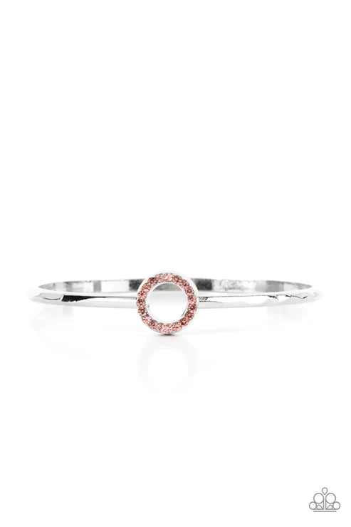 Center COUTURE - Pink and Silver Bracelet - Paparazzi Accessories - Brilliant dainty pink rhinestones set in a shiny silver round frame, create a glitzy circle in the center of a subtly hammered silver bangle. ﻿Sold as one individual bracelet.