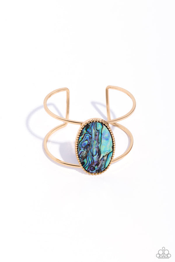 Enigmatic Energy - Gold Cuff Bracelet - Paparazzi Accessories - Featuring a faux abalone shell center, a textured gold oval frame sits atop an airy gold cuff for a seasonal look. Sold as one individual bracelet.