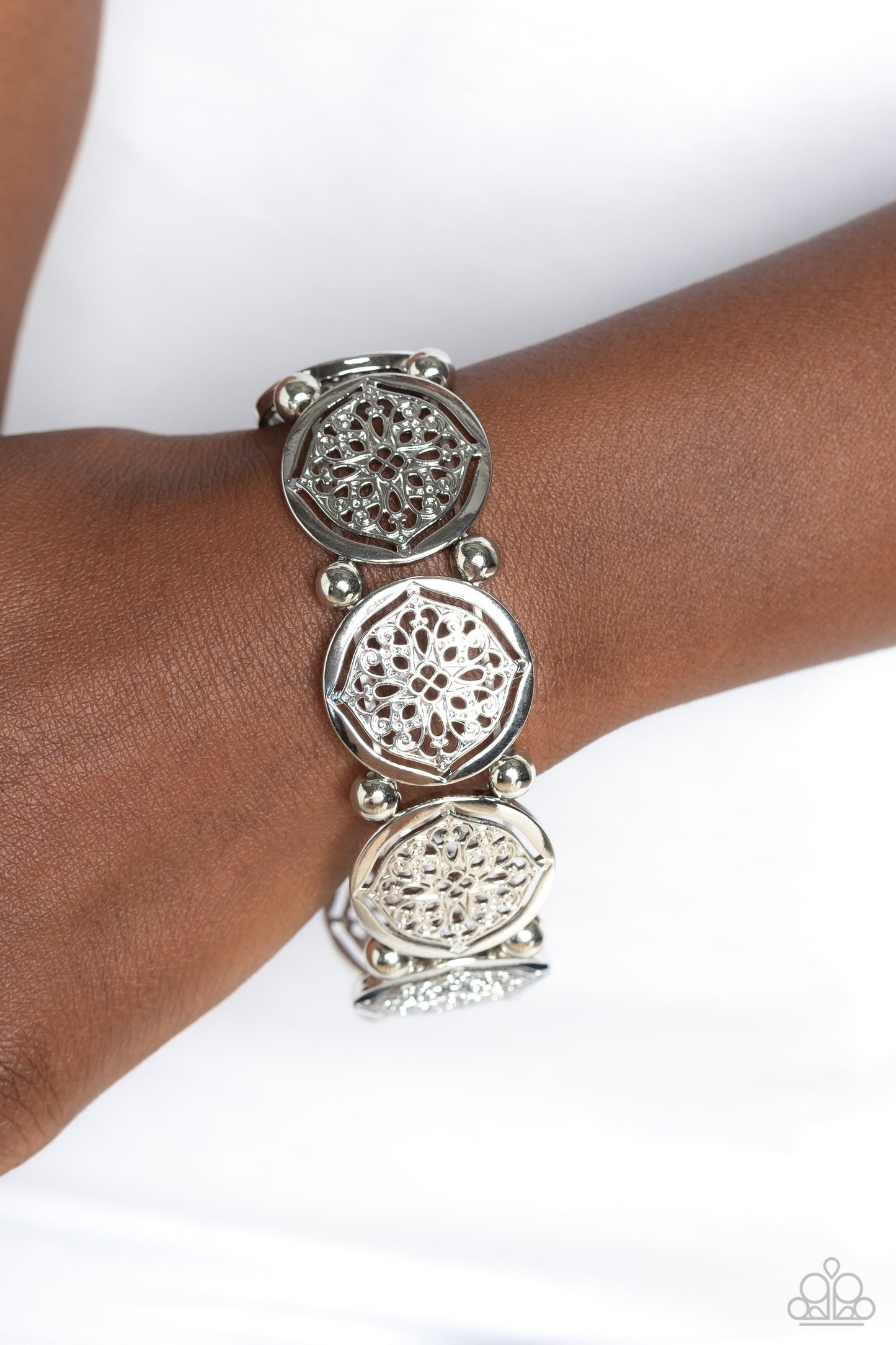 Filigree Fanfare - Silver Bracelet - Paparazzi Accessories - Filled with shiny floral-like filigree, a collection of glistening silver discs links around the wrist on a stretchy band for a whimsical fashion. Silver beads separate each floral display for additional high-sheen shimmer.