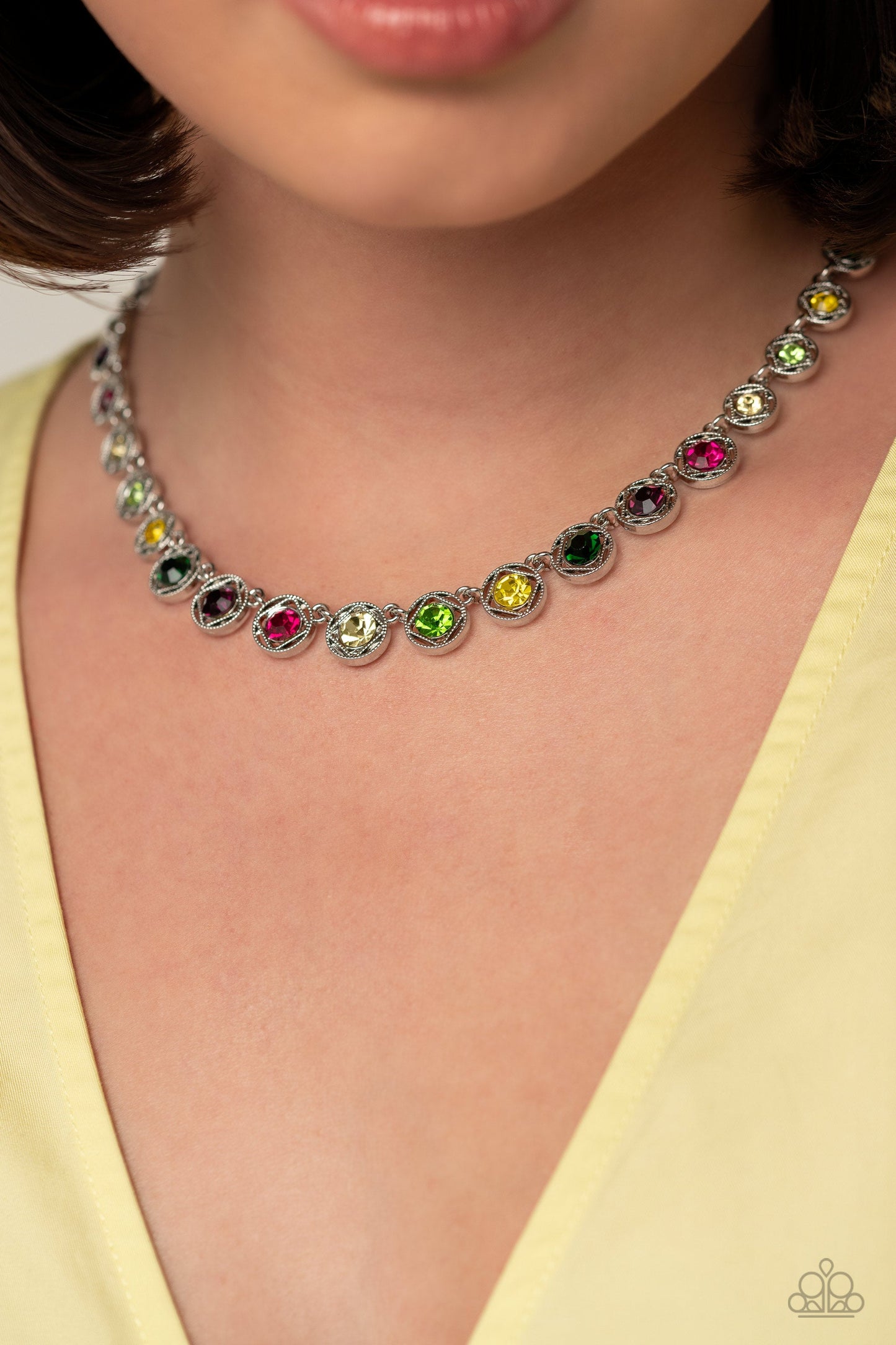 Kaleidoscope Charm - Multi Color and Silver Necklace - Paparazzi Accessories - Spanning around the entirety of the neckline, a refined collection of colorful rhinestones are pressed into airy, studded, silver square frames, tilted on their sides for a three-dimensional shimmer. The frames and rhinestones gradually increase in size as they fall down the neckline, accentuating their colorful sparkle.