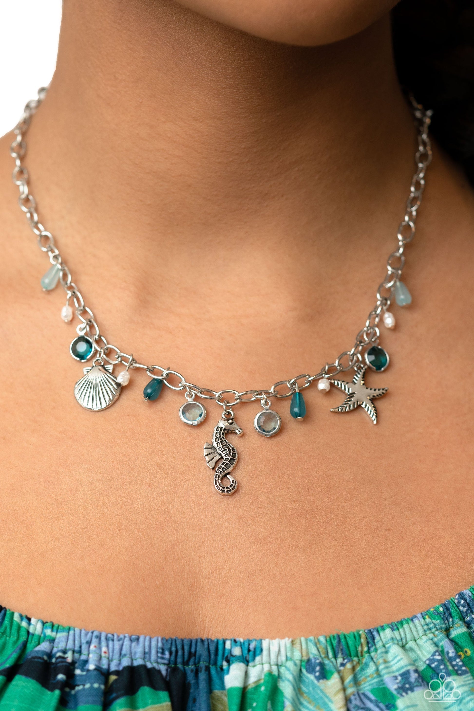 Seahorse Season - Blue and Silver Necklace - Paparazzi Accessories - Dainty baroque pearls, clear Harbor Blue and Waterspout faceted beads in silver frames, intricate silver seahorse, starfish, and sea scallop seashell charms, and milky Harbor Blue and Waterspout teardrop beads swing from a silver link chain, creating a beachy fringe below the collar. Features an adjustable clasp closure.
Sold as one individual necklace.