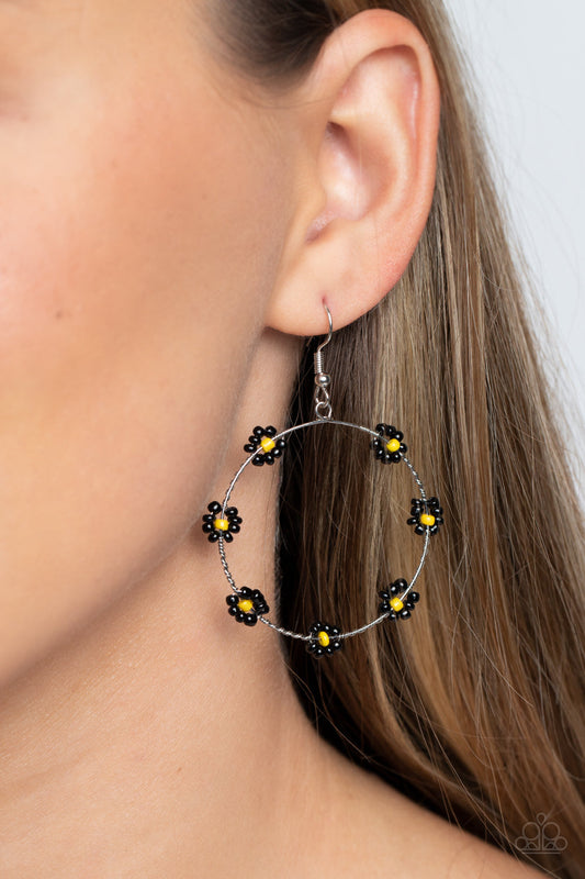 Dainty Daisies - Black and Yellow Earrings - Paparazzi Accessories - Dotted with yellow seed beaded centers, a dainty collection of black seed beaded floral frames are threaded along a dainty, serrated wire hoop for a fabulous floral fashion earrings.